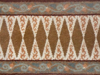 Close up of carpet rug design in classic vintage diamond ornamental pattern. Swirls, engraving, and diamonds repetitive pattern, table runner or carpet seamless background texture. clipart