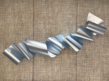 Random curved metallic metal stainless steel plate forming a shawl, mounted on a grey fabric upholstered panel wall background. clipart