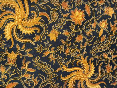 Geleneksel etnik rastgele çiçekli ve süslemeli desenleri mavi, sarı ve turuncu renklerle kapatın. Endonezya 'dan geleneksel Batik arkaplan dokusu.