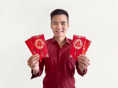 An asian man holding Chinese red envelopes, also known as hongbao or angpao. Red envelope is filled with money and famous for Chinese New year. The Chinese word Fu means Blessing. On white background. clipart