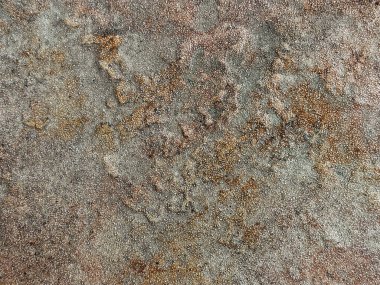 Paslı ve yıpranmış granit taş dokusu, dış ve dış döşemeler için uygun. Oksitlenmiş, bakır ve gri renkli. Kusursuz taş arkaplan dokusu.