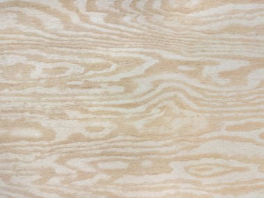 Sarı tahta panele oyulmuş soyut dalga deseni. Tahta damarlar bej renkli şekiller. Kusursuz arkaplan dokusu.