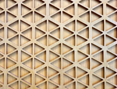 Kontrplaktan oyulmuş geometrik altıgen şekilli deseni kapat. 3D kesme lazer kesim altıgen şekiller sıcak, parlak ahşap tonuyla tamamlandı. Kusursuz arkaplan dokusu.