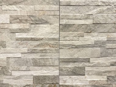 Doğal dikdörtgen tuğla şekilli, gri doğal renklerde. Taştan ya da kaya fayanslarından oluşan yatay çizgiler. Kusursuz arkaplan.