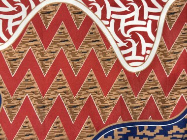 Geleneksel etnik kumaş. Rastgele süslenmiş ve sembol desenli. Kahverengi ve kırmızı renkli klasik etnik boyalı kumaş. Kusursuz arkaplan dokusu. Endonezya batik illüstrasyonu.