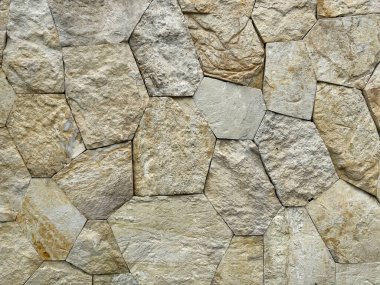 Rastgele kesilen bej sarı çakıl taşı yüzeyde düzleştirilmiş. Döşeme ya da duvar işi bitsin diye rastgele ve beton kaplı sert kaldırım taşı ve çakıl yığını. Kusursuz arkaplan dokusu.    