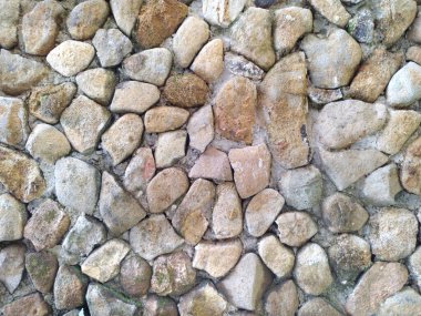 Çakıl taşı duvarını, bahçe duvarındaki dekoratif malzemeler gibi kapat. Çakıl taşları, kuvars dekorasyonu için iyi bir seçimdir..