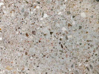 Renkli açık gri terrazzo renkli kuvars taş desenli. Terrazzo, çağdaş kenar ve şık iç mekanlarda duvar ya da zemin kaplaması olarak giderek daha çok kullanılıyor..