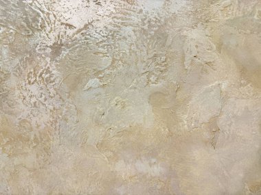 Bir grunge ya da kaba bej bir duvar boyasının toprak dokusunu kapat. Kremsi bej renginde desenli boya, dekoratif boya. Epoksi ile kaplanmış. Kusursuz arkaplan dokusu.