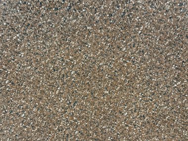 Siyah ve beyaz noktalı kahverengi terrazzo granit taşına yakın çekim. Koyu kahverengi granit taş dikişsiz arkaplan dokusu.