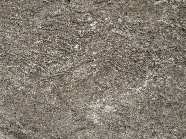 Yıpranmış koyu taş dokusunu kapatın, dış ve dış malzemeler için uygun. Sert yüzeyi olan gri mineral granit levha taşı. Kusursuz taş arkaplan dokusu.