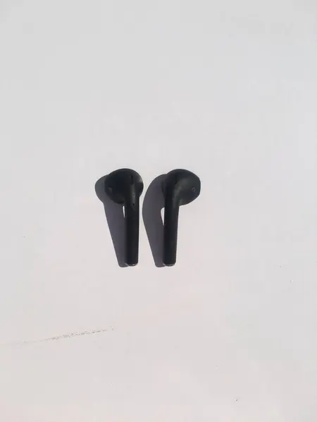 stock image BLACK APPLE AIRPODS ISLOATED ON WHITE BACKGROUND.