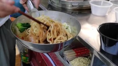 Baharatlı erişte ve soya yumurtasıyla karıştırılmış yemek çubukları, para ve diyet kavramı, geniş açı.