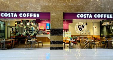 Gurugram, India - August 7, 2024 : Vibrant Costa Coffee shop interior, modern seating, and inviting ambiance in a bustling urban shopping center. Best place for coffee lover in India clipart