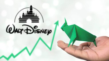 New York- USA, 25 Dec 2024: WALY DISNEY Stock Uptrend with Selective Focus on green origami Bull, symbolising  WALY DISNEY  Bullish market trend. Captures the concept of Financial Growth clipart