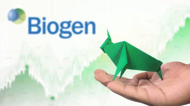 New York - ABD, 25 Aralık 2024: BIOGEN Stock Uptrend with Selective Focus on green origami Bull, sembolize edilen BIOGEN Bullish pazar trendi. Finansal Büyüme kavramını yakalar