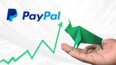 New York- USA, 23 Jan 2025: PAYPAL Stock Uptrend with Selective Focus on green origami Bull, symbolising PAYPAL Bullish market trend. Captures the concept of Financial Growth clipart