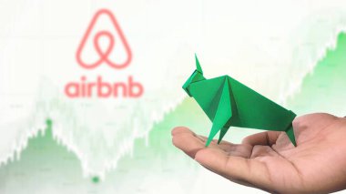 New York- USA, 23 Jan 2025: AIRBNB Stock Uptrend with Selective Focus on green origami Bull, symbolising AIRBNB Bullish market trend. Captures the concept of Financial Growth clipart