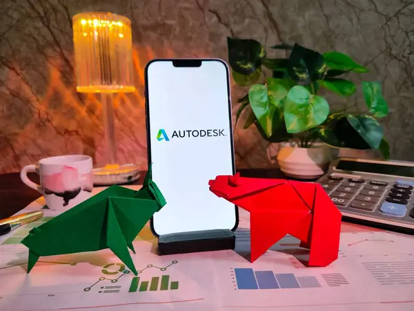 NewYork, ABD - 15 Aralık 2024: Finansal içgörüler için AUTODESK Inc logosuna sahip grafikler, grafikler, hesap makinesi ve kahvenin yer aldığı AUTODESK Inc.