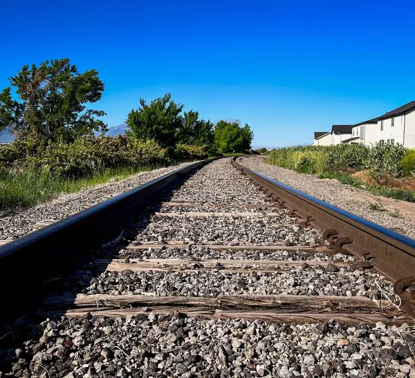 stock image Train Tracks Behind a Neighborhood Disappearing into the Distance