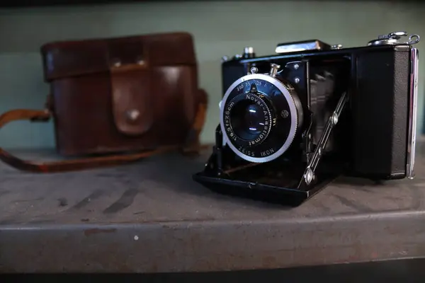 Ahşap bir masada klasik bir kamera.