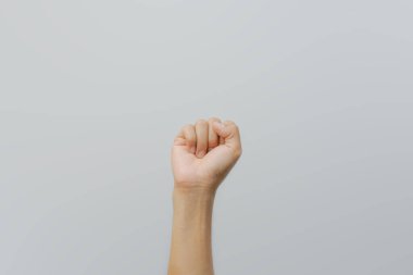  Kapalı bir yumruğu tasvir eden bir resim, muhtemelen gücü, kararlılığı ya da meydan okumayı simgeliyor. Beyaz arka plan minimalist bir estetik yaratıyor ve konuyu vurguluyor.