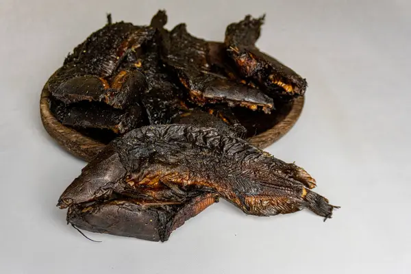 stock image smoked catfish on white isolated , the image has a clean and simple background, highlighting the fish. traditional food from South Tapanuli, Indonesia