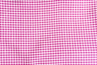 close-up texture of pink and white checkered fabric, creating a repeating pattern.