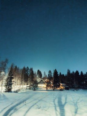 Karlı kış ormanlarında ev Rovaniemi 'de, Laponya' da kutup gecesinde