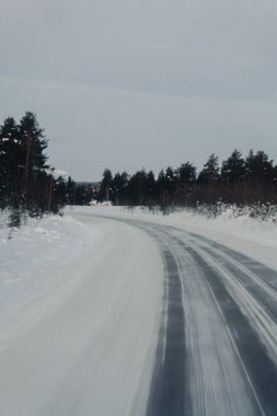 Snowy road through the arctic wilderness in Ranua, Lapland