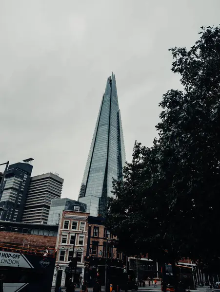 Bulutlu gökyüzündeki Çömlek Londra, İngiltere 'deki ağaçların arkasında.