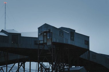 Building of an old coal mine in the snowy arctic winter, Longyearbyen, Svalbard clipart