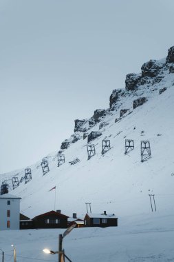 Aerial mining cableway on snowy mountainside in Longyearbyen, Svalbard clipart