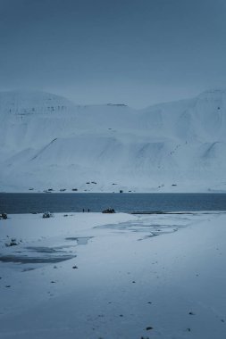 Frozen river leading out to the arctic ocean in Longyearbyen, Svalbard clipart