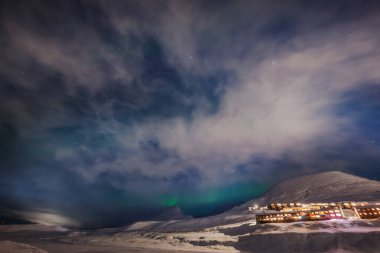 Northern lights above the northernmost town in the world, Longyearbyen, Svalbard clipart