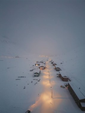 Foggy aerial shot of Nybyen neighbourhood in Longyearbyen, Svalbard clipart