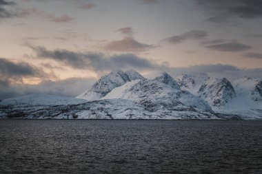 Karlı Lyngen Alp Dağları 'nın Kuzey Buz Denizi kıyısındaki manzarası, Norveç kışları