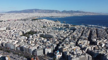 An aerial photo of the city center of Athens, Greece, showcasing the blend of modern urban life and historic architecture, with a beautiful view of the citys streets and iconic landmarks clipart