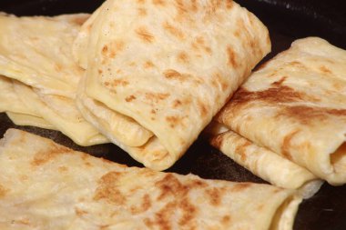 A close-up of the traditional Moroccan flatbread known as Msemmen or Msemen clipart