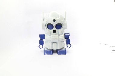 A white and blue robot-shaped pencil sharpener is sitting on a white background. clipart