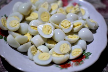 A close-up captures a serving of halved hard-boiled eggs. clipart