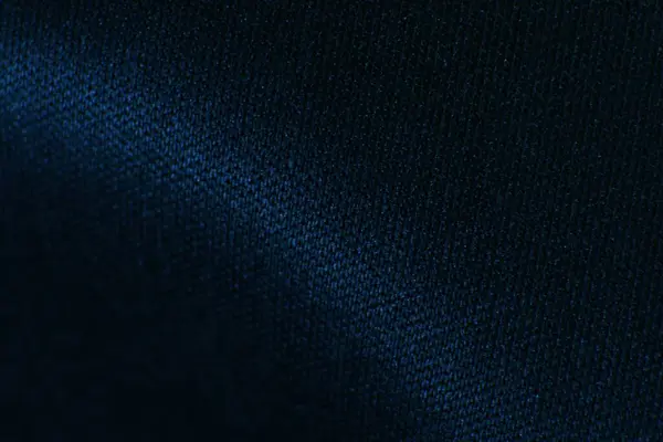 Derin mavi kumaş dokusuna yakın plan, arka plan ve tasarımlar için ideal.