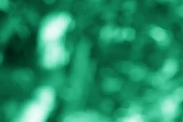 Yumuşak bir bokeh efektini gösteren soyut bir yeşil arka plan, herhangi bir projeye biraz dinginlik katmak için idealdir, enerjik ama yine de sakinleştirici bir his verir.