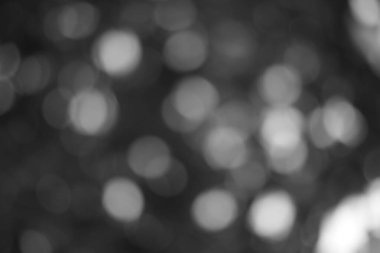 Bulanık dairesel şekilleri, hafif ışığı ve koyu dokuları olan ruhani tek renkli bokeh arkaplan