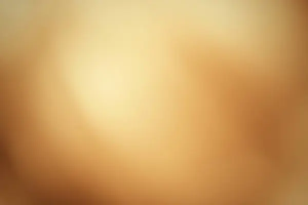 Bulanık karamel gradyanı, yumuşak, ışık soyut arkaplan. Odaklanmamış altın doku.