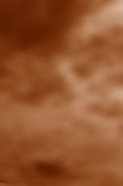 Kehribar tonlarının akışkan bir karışımı yumuşak desenli, yumuşak odaklı soyut bir arkaplan yaratır.