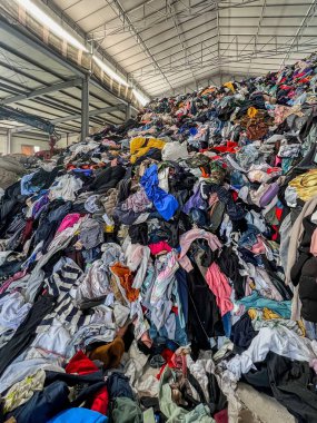 Depo İkinci el kıyafetlerle dolup taşıyor Küçük Tepeler 'e benzeyen büyük yığınlar oluşturuyor.