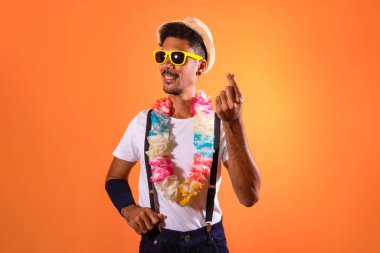 Carnival Outfit Party. Portrait of Black Man With Carnival Props Isolated on Orange Background, space for text. 