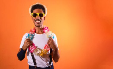 Carnival Outfit Party. Portrait of Black Man With Carnival Props Isolated on Orange Background, space for text. 
