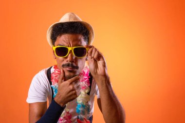 Carnival Brazilian Outfit. Black Man With Carnival Costume Having Fun,  Isolated on Orange Background